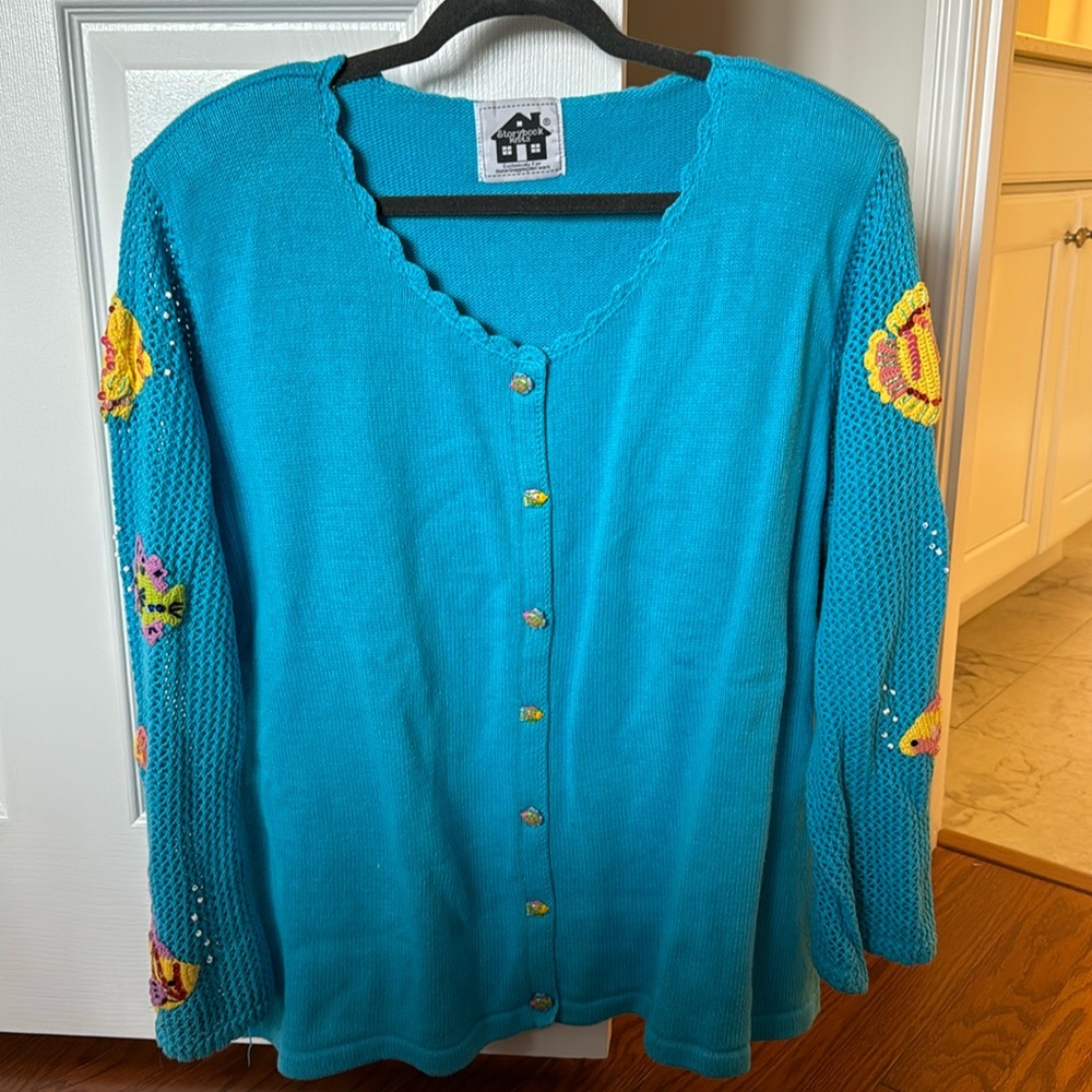 Turquoise sweater with fish